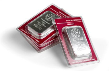 Kyiv, Ukraine - December 05, 2018, several minted silver bars in transparent blister pack produced by the Swiss factory Argor-Heraeus - is one of the worlds largest processors of precious metals. On a white background. clipart