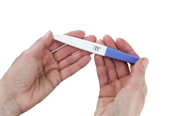 女性手持有阳性的孕检 隔离在白色背景上 — 图库照片