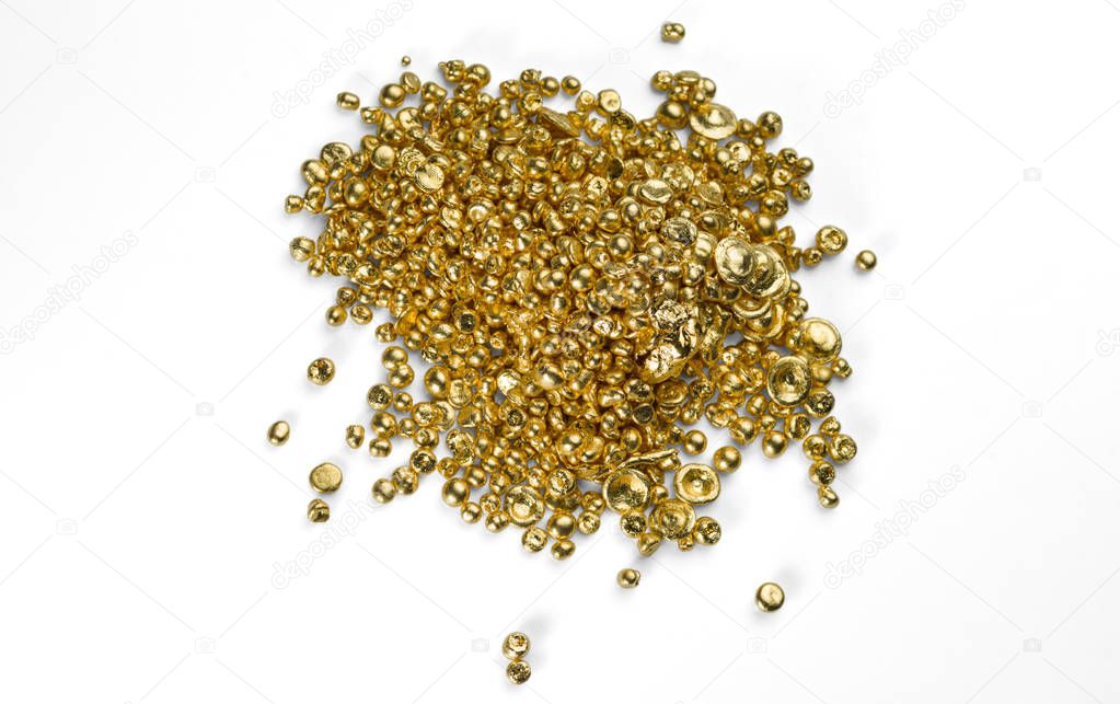 A bunch of pure gold granules isolated on a white background.