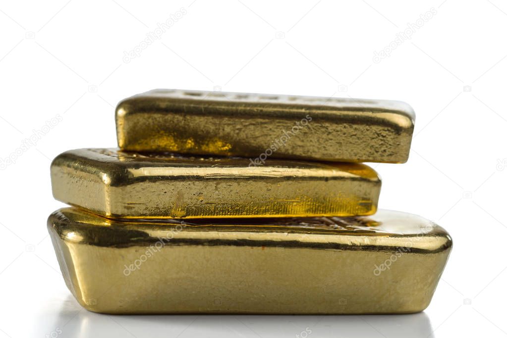Three gold bullion bars isolated on white background.