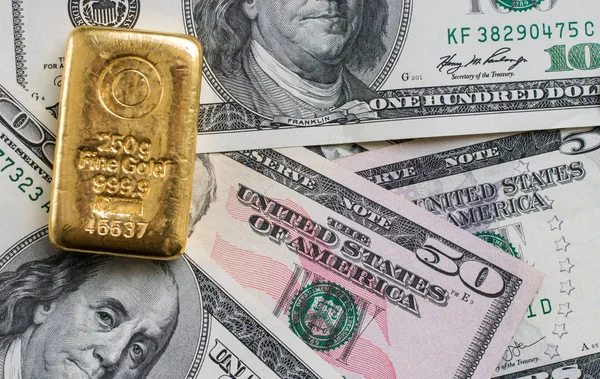 Barra Ouro Fundido Pesando 250 Gramas Contra Fundo Notas Dólar — Fotografia de Stock