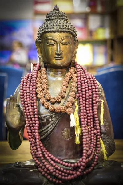 metal buddha statue with ornaments, oriental deity