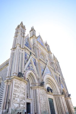 Facade of the Cathedral of Orvieto (Duomo di Orvieto) Italy. Construction in Gothic style dedicated to the Madonna clipart