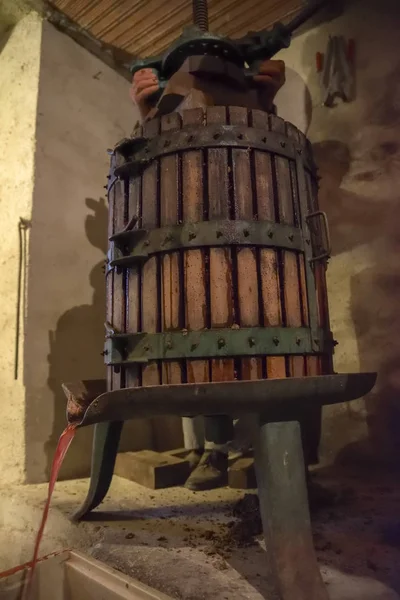 Winemaking. Old wooden wine press with must inside. Pressing of grapes for red wine