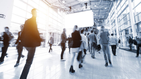 blurred business people at a trade fair