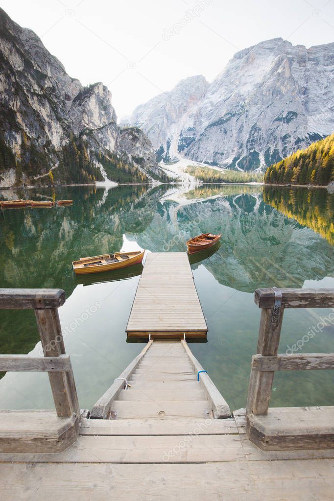 Traditional rowing boats at Lago di Braies at sunrise in fall, South Tyrol, Italy