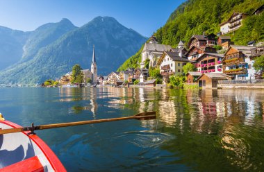 Classic view of Hallstatt with traditional rowing boat in summer clipart