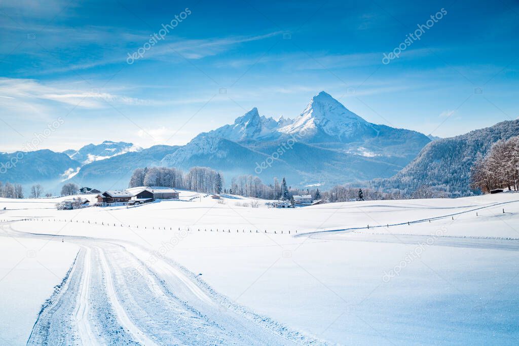 Beautiful winter scenery in the Alps on a cold sunny day with blue sky and clouds