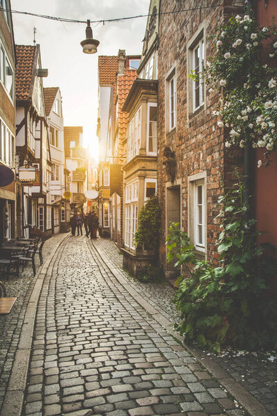 Beautiful view of old town in Europe in beautiful golden evening light at sunset in summer with pastel toned retro vintage Instagram style grunge filter and lens flare sunlight effect