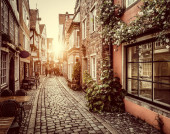 Картина, постер, плакат, фотообои "beautiful view of old town in europe in golden evening light at sunset in summer with pastel toned retro vintage instagram style grunge filter and lens flare sunlight effect", артикул 393561234