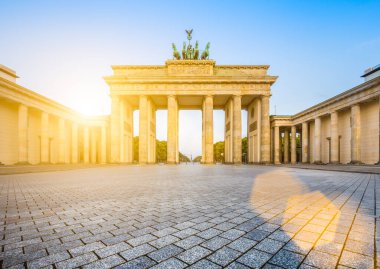 Famous Brandenburger Tor (Brandenburg Gate), one of the best-known landmarks and national symbols of Germany, in beautiful golden morning light at sunrise with lens flare effect, Berlin, Germany clipart