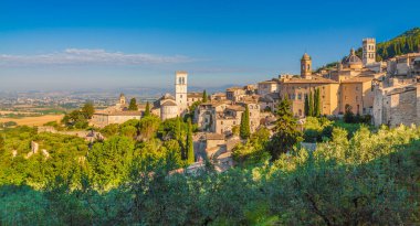 Panoramic view of the historic town of Assisi in beautiful golden morning light at sunrise in summer, Umbria, Italy clipart