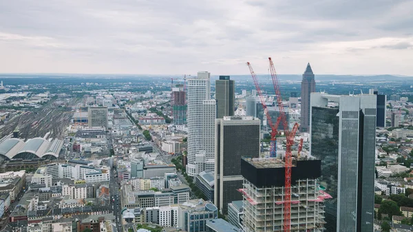 Aerial view of cityscape with skyscrapers and buildings near crane in Frankfurt, Germany — Stock Photo