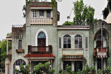 Rizal Bulvarı ve Burgos Caddesi 'nin köşesinde, yağmurun altında doğuya doğru Bohol Denizi' ne bakan yeşil duvarları olan eski bir malikane. Dumaguete-Zenciler Doğu-Merkez Visayas-Filipinler.