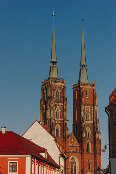 antique Cathedral of St John Baptist in front of blue sky, Wroclaw, Poland