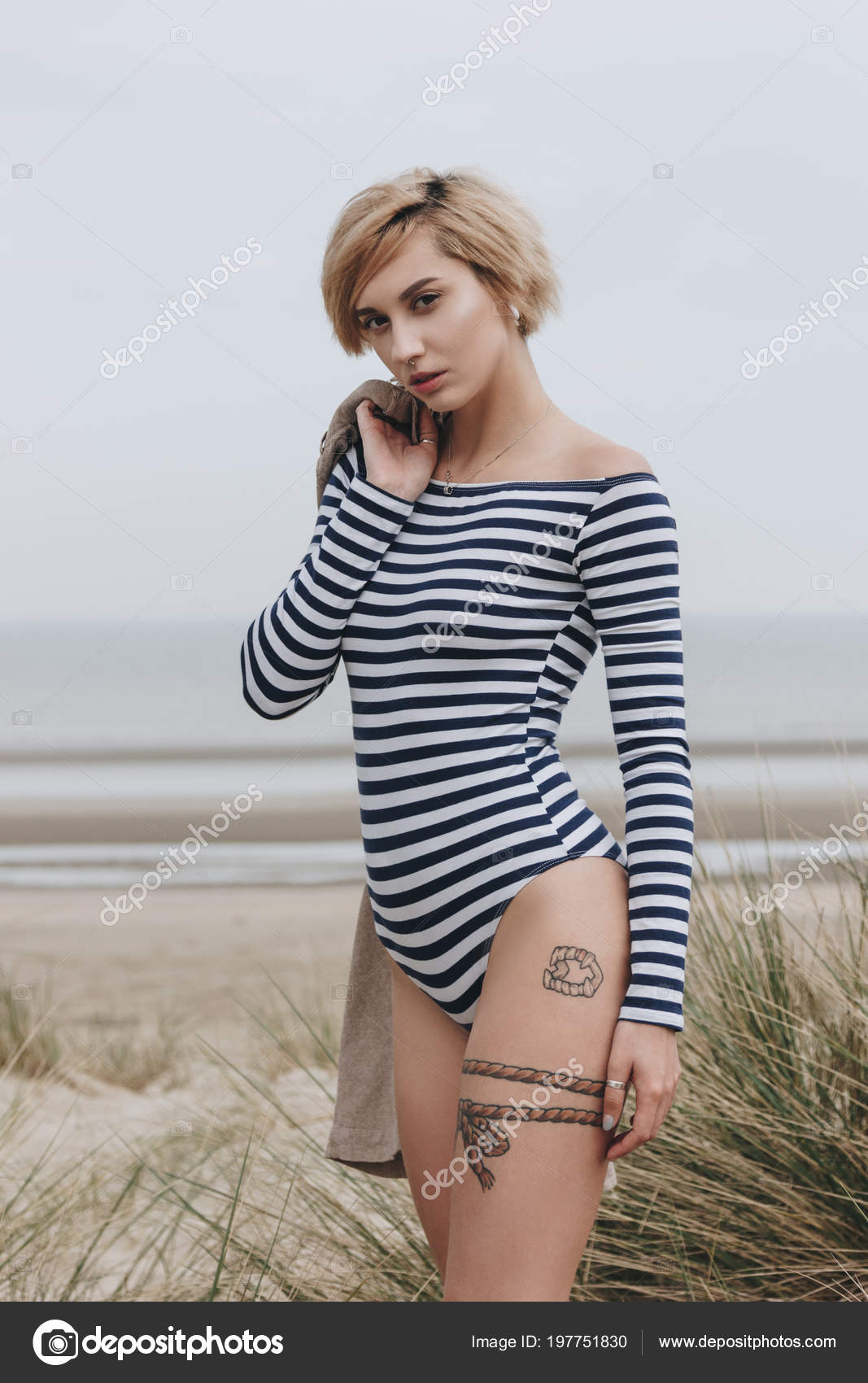 Beautiful Young Woman Striped Bodysuit Sandy Shore Cloudy Day Stock Photo  by ©IraGirichBO 197751830