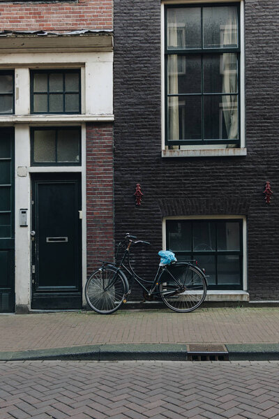 facade of old building with parked bicycle, Amsterdam, Netherlands