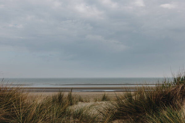 dramatic shot of sandy seashore on cloudy day, Bray Dunes, France