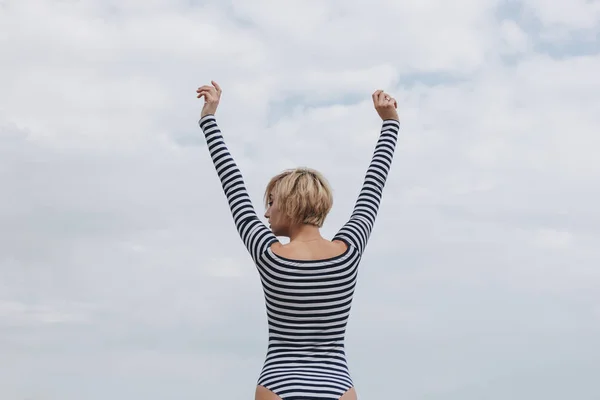 Rear View Young Woman Striped Bodysuit Raised Arms Cloudy Day — Stock Photo, Image