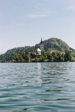 beautiful architecture and scenic lake in mountains, bled, slovenia clipart