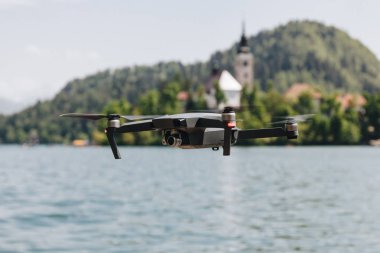 close-up view of flying drone above mountain lake, bled, slovenia clipart