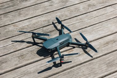 close-up view of quadcopter on wooden surface at sunny day clipart