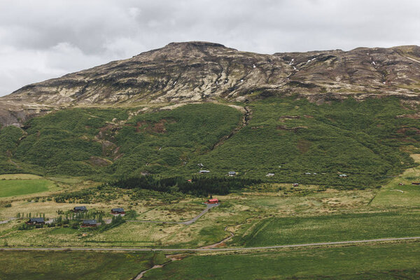 aerial view of landscape with houses and mountains range in Iceland 