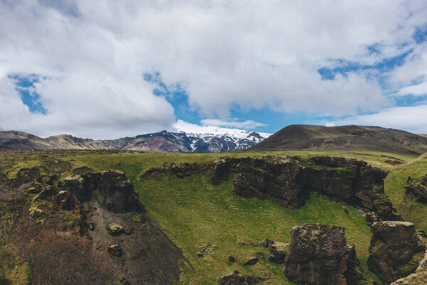 scenic view of landscape with mountains range under blue cloudy sky in Iceland 
