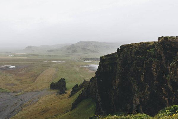 aerial view of landscape with fog over mountains in Vik, Iceland