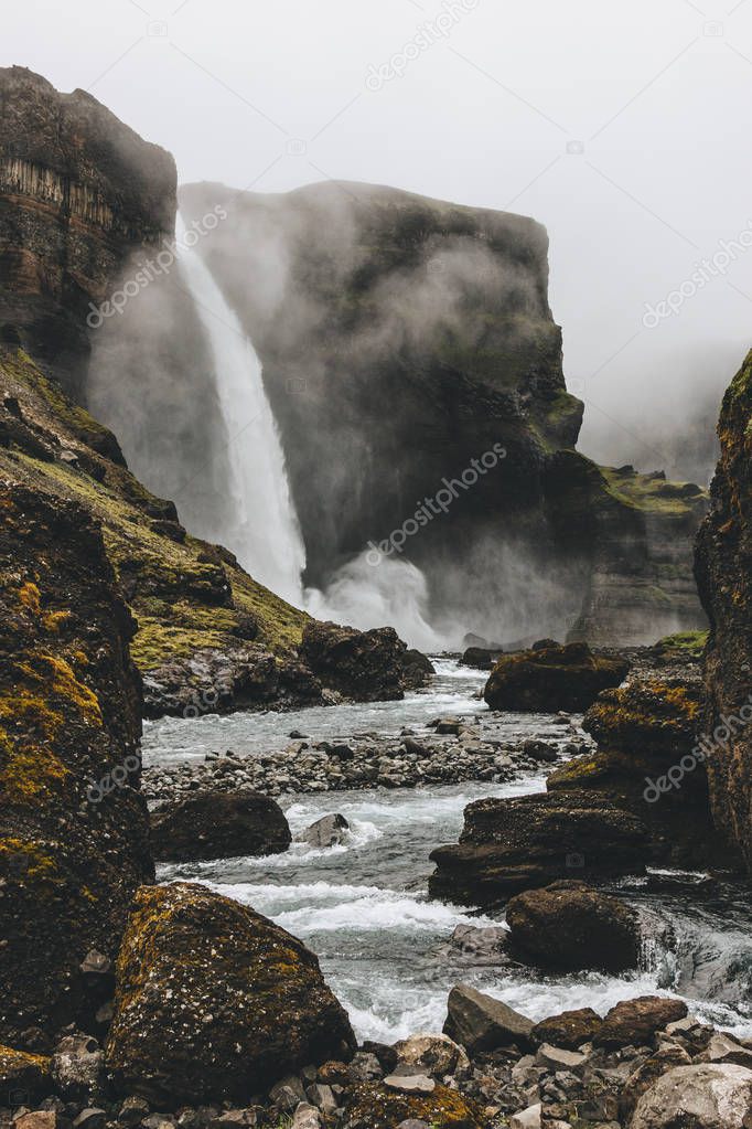 dramatic icelandic landscape with Haifoss waterfall on misty day