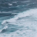 Aerial view of ocean with foamy waves for background