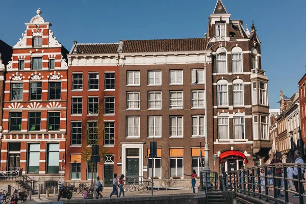 20 MAY 2018 - AMSTERDAM, NETHERLANDS: facades of old buildings on street of Amsterdam on sunny day — Stock Photo