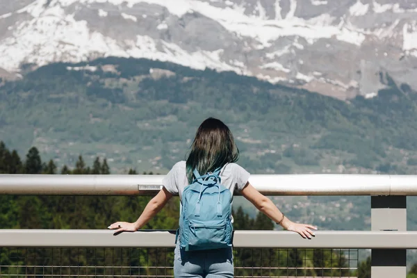 Вид ззаду дівчини з рюкзаком, дивиться на величні мальовничі гори, Монблан, Альпи — стокове фото