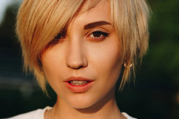 Close-up portrait of beautiful young blonde woman looking at camera — Stock Photo