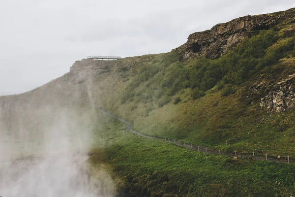 Scenic view of landscape with steam and road leading through highlands in Iceland — Stock Photo