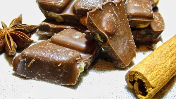 Pile of chocolate with nuts. chocolate bar pieces / nut chocolate/ chocolate background