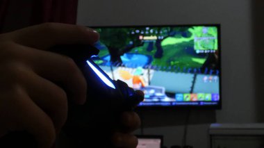 Fortnight video games play a close-up of footage. Man plays a popular game with a big screen TV. May 28, 2019. Italy Rome clipart