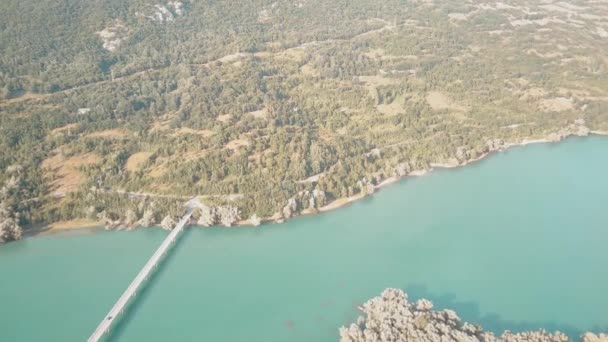 View from the drone, Landscape of Barrea Lake, the village of Villetta Barrea and the Marsicano Moun with cloud in background. Abruzzo, Lazio and Molise National Park, Italy — Stock Video