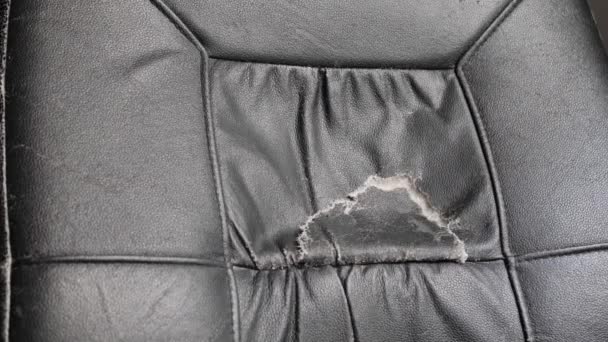 Поврежденное офисное кресло с черной кожей — стоковое видео