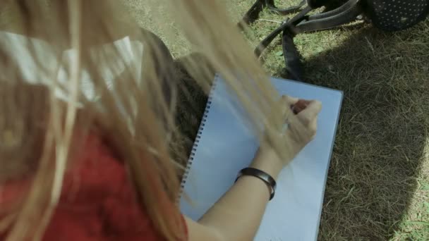 Female students hand with pen writing in notebook — Stock Video