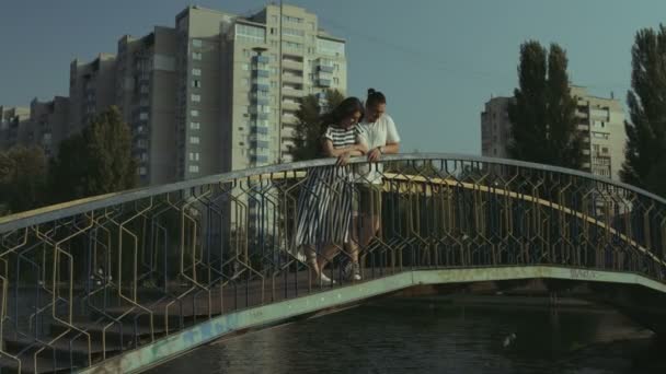 Sonriente pareja enamorada abrazándose en el puente — Vídeos de Stock