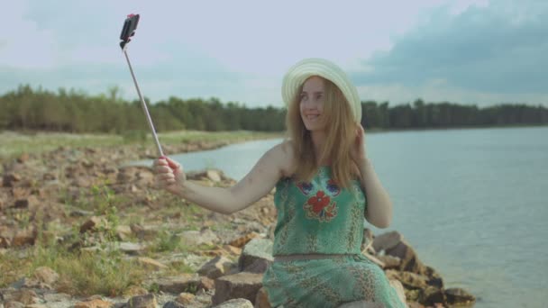 Joyful woman taking selfie on smart phone on beach — Stock Video