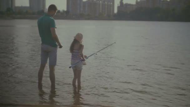 Fürsorglicher Vater und süße Tochter angeln am Fluss — Stockvideo