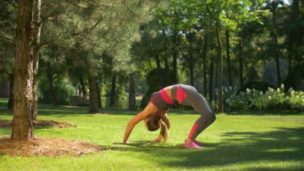 Adatto donna sportiva facendo backbend esercizio all'aperto — Video Stock