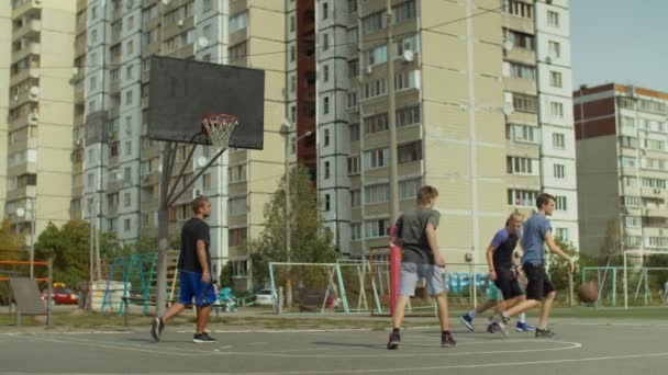 Streetball hráči hrát basketbal na kurtu — Stock video