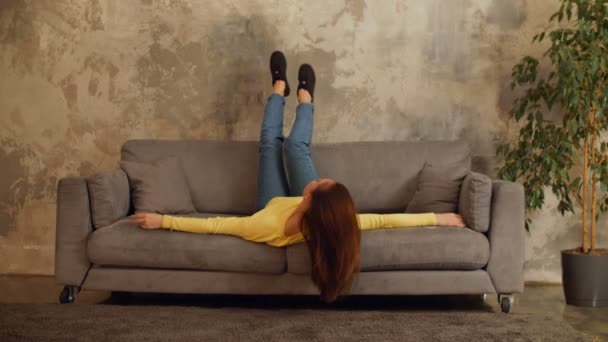 Beautiful Carefree Woman Lying Sofa Head Upside Loft Apartment Cheerful — Stock Video