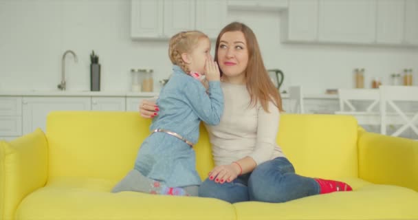 Schattig klein meisje geheim delen aan moeder thuis — Stockvideo