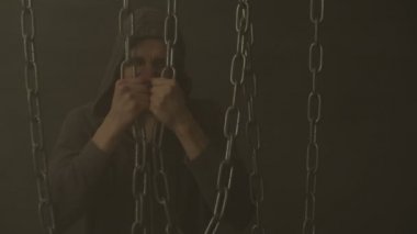 Demir zincirleri iç yırtılma kapüşonlu adam