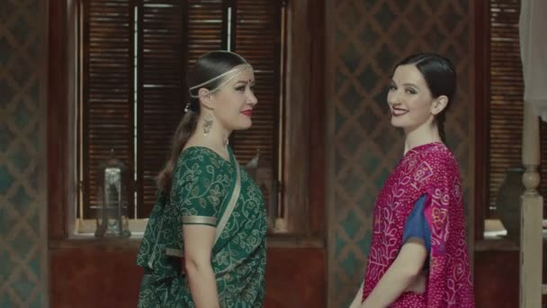 Two attractive women in sari with beaming smiles — Stock Video