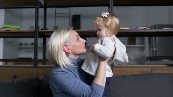 Hablando con una niña pequeña madre sosteniendo a un niño alto — Vídeo de stock